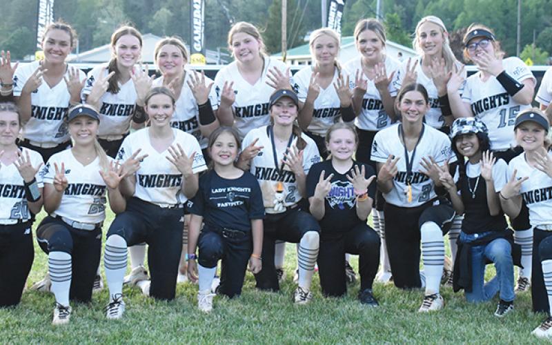 Although the Robbinsville Lady Knights wrapped up their 16th Smoky Mountain Conference title one day prior, the players wanted to signify their 7th-straight divisional crown by gathering in the outfield moments after sweeping the regular-season series against Murphy on May 2. Photo by Kevin Hensley/sports@grahamstar.com