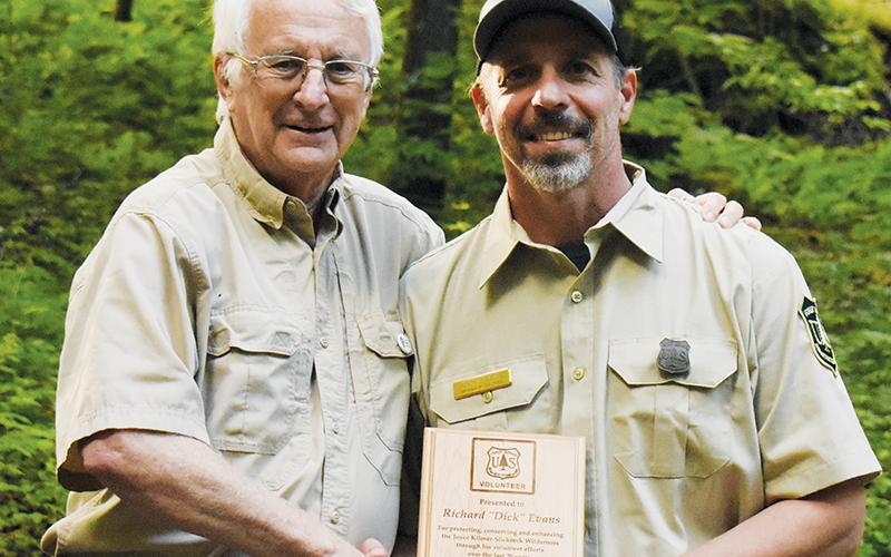 Richard “Dick” Evans (left) was surprised by Heath Emmons with the U.S. Forest Service and the Partners of Joyce Kilmer-Slickrock Wilderness on Monday with the Region 8 Volunteer of the Year Award. Photo by Kevin Hensley/editor@grahamstar.com