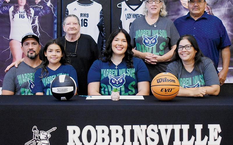 Fresh off high school graduation two months ago, Aubrie Wachacha solidified her immediate plans for the future by signing to play both volleyball and basketball at Warren Wilson College. Sitting with Wachacha are father Randy Wachacha (left), sister Amara Wachacha and mother Monaka Wachacha. Standing in back (from left) are grandmother Carolyn Wachacha, plus Debbie and John Bird. Photo by Kevin Hensley/sports@grahamstar.com
