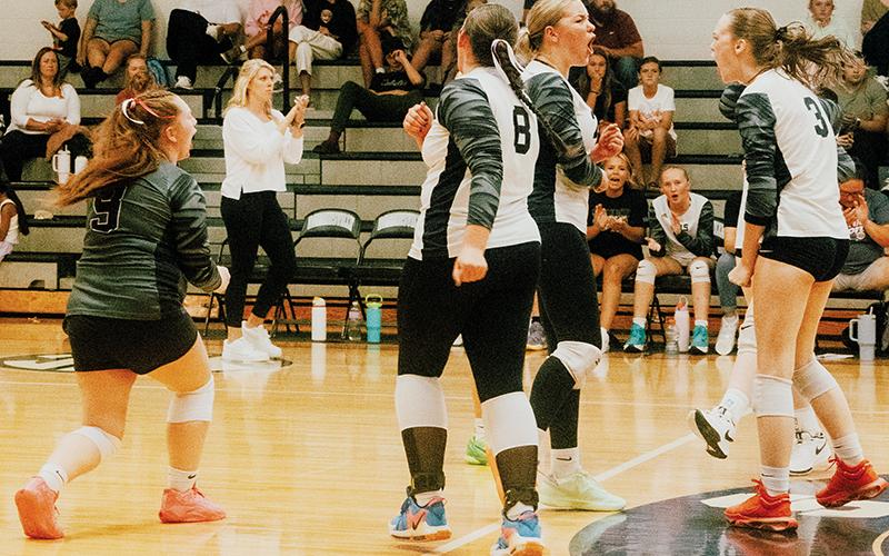 Robbinsville’s seniors Olivia Lewis (9), Liz Carpenter (center) and Claire Barlow (3) celebrate Barlow’s stout block in the closing moments of set one Monday against T.C. Roberson. The Lady Knights swept the Lady Rams in the season premiere. Also pictured on the court is Ryn Hooper (8); Daphne Barlow is behind Claire. Photo by Royce Worbington/The Graham Star