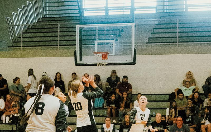 Senior Liz Carpenter (20) prepares for a pass to freshman Daphne Barlow (5) during Aug. 12’s season opener against T.C. Roberson. Photo by Royce Worbington/The Graham Star