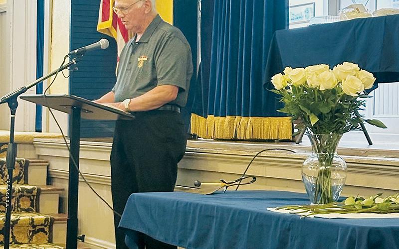 C.E. Holder reads a list of those Stecoah graduates who have passed away since last year’s reunion Saturday. For each, a rose was placed in the vase.