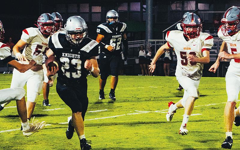 Luke Green (23) looks to give the quick slip to a heavy Cougar pursuit Sept. 12.