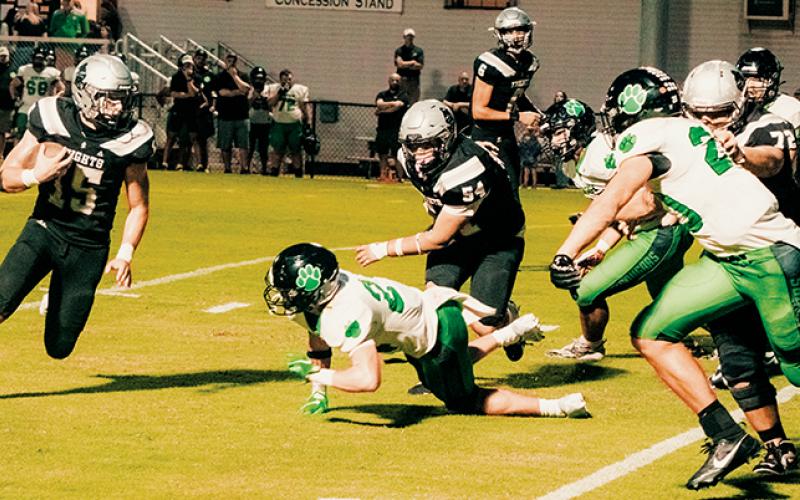 Roman Jones (15) looks for some open room during Friday’s loss to Mountain  Heritage. Jones scored both of Robbinsville’s touchdowns in the game. Photos by Royce Worbington/The Graham Star