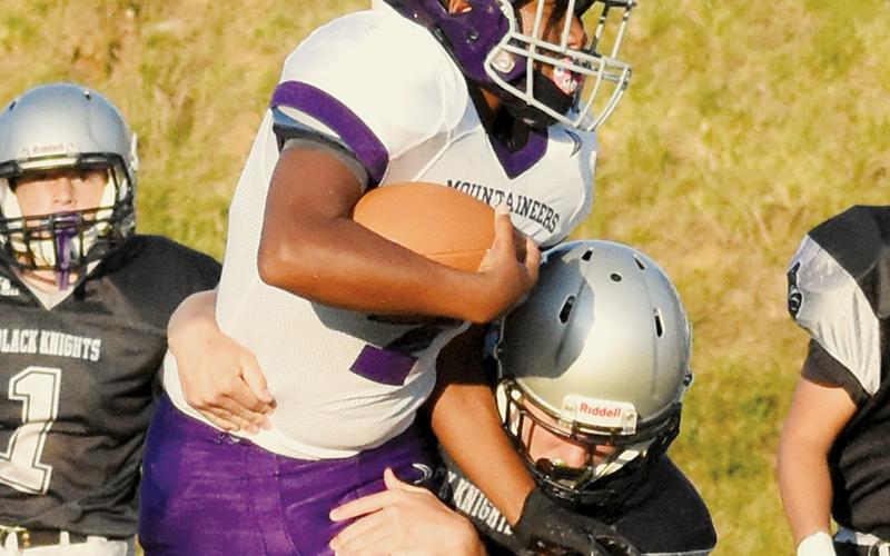 Eli Lambert wraps up a would-be Mitchell rusher during Aug. 22’s season opener. Lambert snagged the game-winning touchdown catch last week at Mountain Heritage. Photo by Jacquline Gayosso/The Graham Star