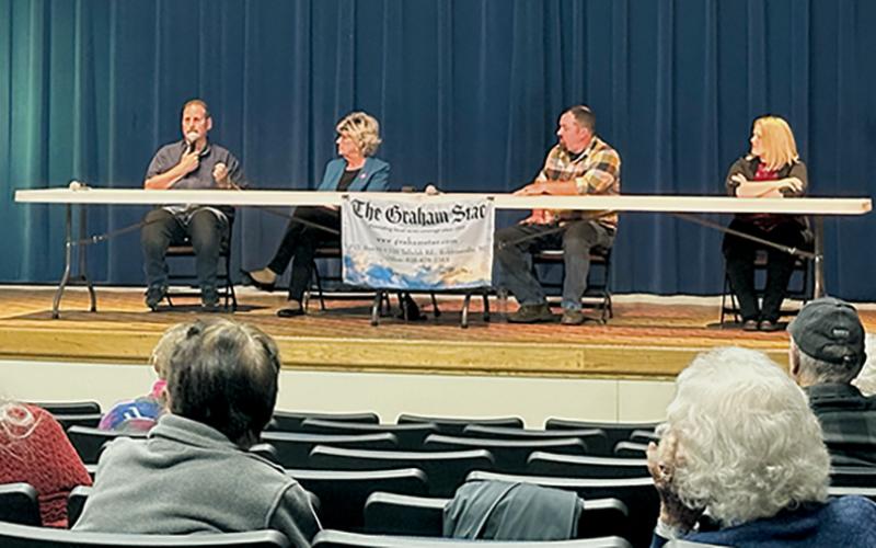 Incumbent commissioner Lynn Cody answers a question during Saturday's candidate forum at Robbinsville High School. Seated with Cody (from left) are incumbent commissioner Connie Orr, Thomas Menard and Meggan Smith. Photo by Latresa Phillips/The Graham Star