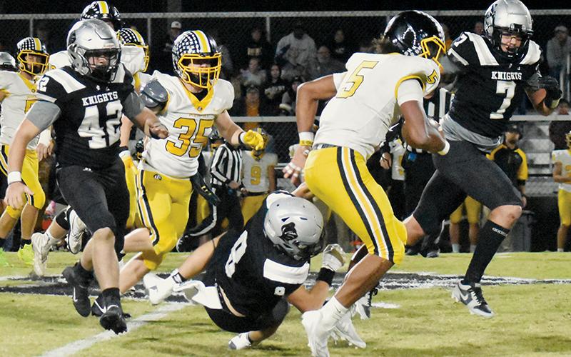 Under heavy pursuit from Ryelon Waldroup (42) and Isiac Collins (7), Murphy’s Cameron Clem sees his progress slowed drastically after Robbinsville senior Caden Lail (8) opts for a low tackle. Photos by Alex Parton/The Graham Star