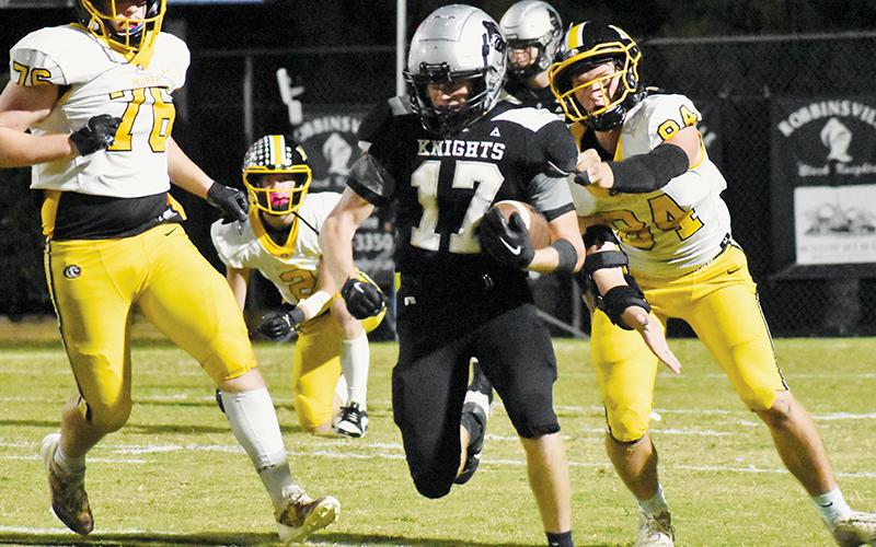 Cooper Adams dashes past Murphy’s Jude Pinkerton (76) and Camden Breazeale in the fourth quarter of Friday’s 14-7 loss to the Bulldogs.