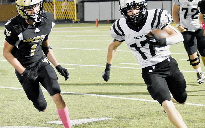 Cooper Adams sprints past Ben Bethel on Friday. The senior running back scored Robbinsville’s lone rushing touchdown in the win over the Yellow Jackets. Photo by Bella Eddings/The Graham Star