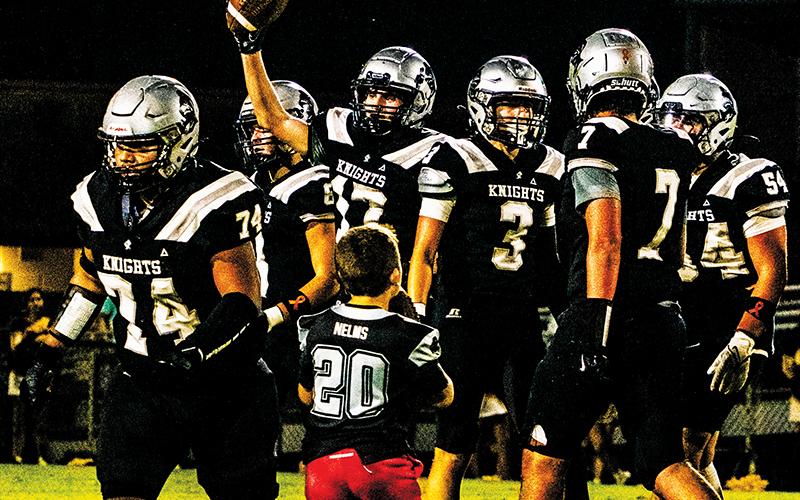 Cooper Adams (17) shows the ball to the home  bleachers after recovering a fumble in his first game back from injury Friday.