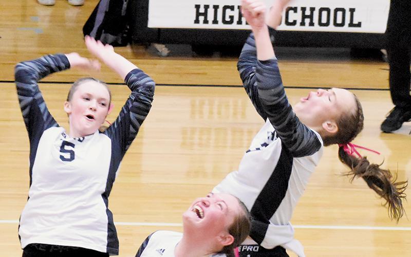 Daphne Barlow, Claire Barlow and Ryn Hooper (clockwise, from top left) celebrate after a block Oct. 10 against Cherokee. Photos by Cheyanne Geyer/The Graham Star