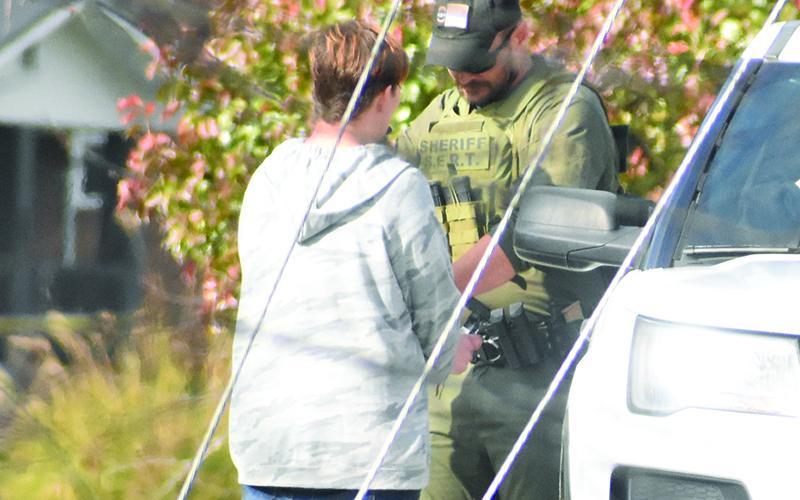 Graham County Sheriff's Office Deputy Jarod Lovelace encounters one of the individuals authorities were searching for around 1 p.m., Tuesday, as part of "Operation Dirty Laundry: Phase 2." The suspect was apprehended just outside the Robbinsville city limits, after being spotted on foot walking north off U.S. Highway 129 (Tapoco Road). Photo by Kevin Hensley/editor@grahamstar.com