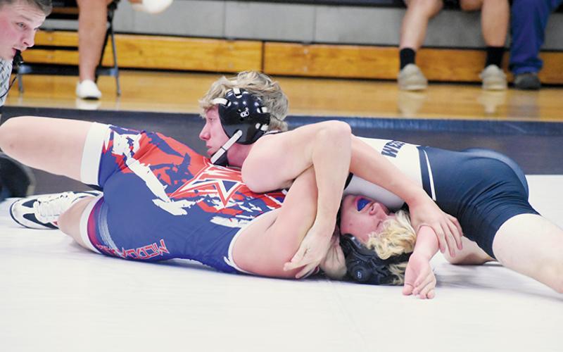 Senior Ethan Webster sprawls out to pin McDowell’s Antonio Molina during Nov. 12’s home dual. Photo by Kevin Hensley/sports@grahamstar.com