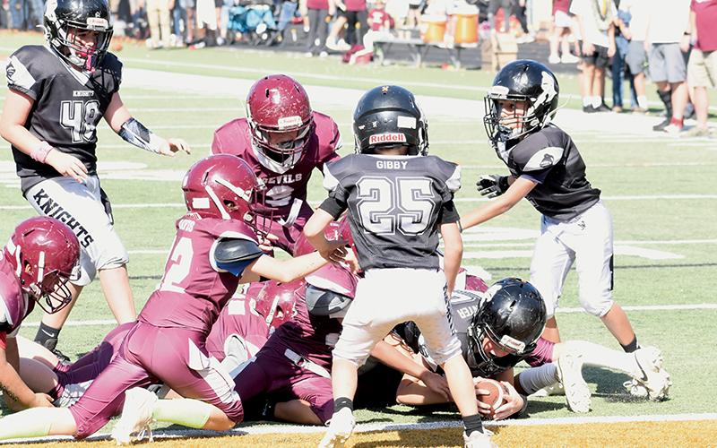 The expression concerning football being a “game of inches” was illustrated nicely by Robbinsville Mites quarterback Kyson Carpenter on Saturday, as the 11-year-old stretched to break the plane and give the Black Knights another Cracker Bowl title. Photos by Kevin Hensley/sports@grahamstar.com