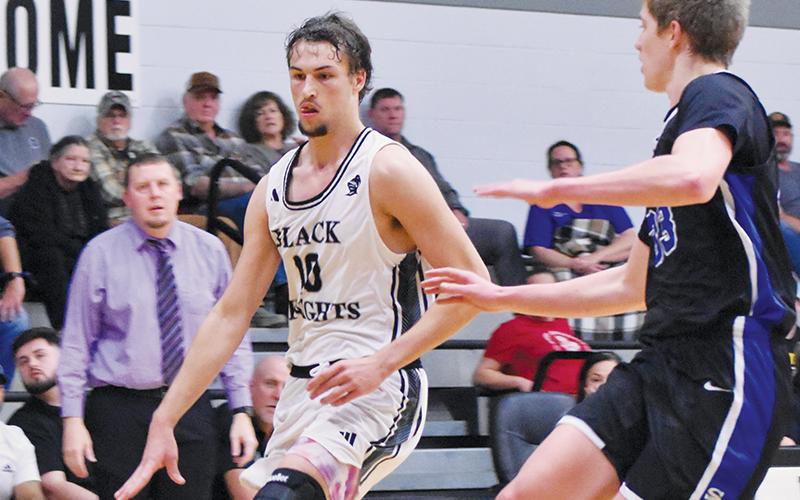 Bryce Adams attempts to dribble around Smoky Mountain’s Custer Pregner during Monday’s home opener. Adams has led Robbinsville’s scoreline in three of the Black Knights’ first four games this season. Photo by Bella Eddings/The Graham Star