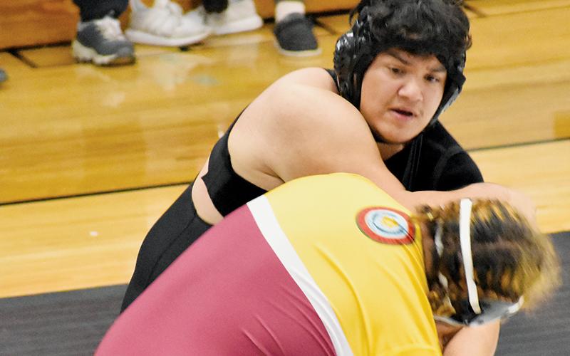 Robbinsville heavyweight Jonah Teesateskie jostles with Cherokee’s Chanttin Tramper on Dec. 18. Photo by Bella Eddings/The Graham Star