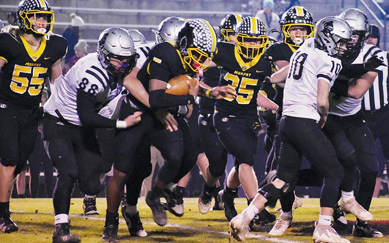 Amidst a first-quarter scrum, Robbinsville’s Kasen Buchanan (88) wraps up  Murphy’s Cameron Clem during Friday’s third-round playoff game. Photo by Bella Eddings/The Graham Star