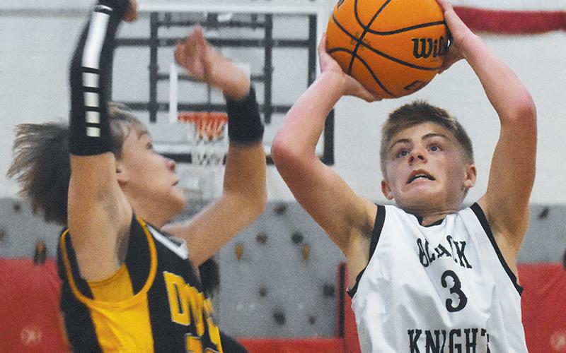 Middle school Black Knight Brayden Allison prepares to shoot around the defense of Murphy’s John Parker Watson during Monday’s loss to the Bulldogs. Photo by Kyla Garland/The Graham Star