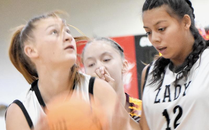 With Aaliyah Wolfe (12) running interference,  Robbinsville Middle’s Ella Nelms eyes a basket Monday against Cherokee. Photo by Bella Eddings/The Graham Star