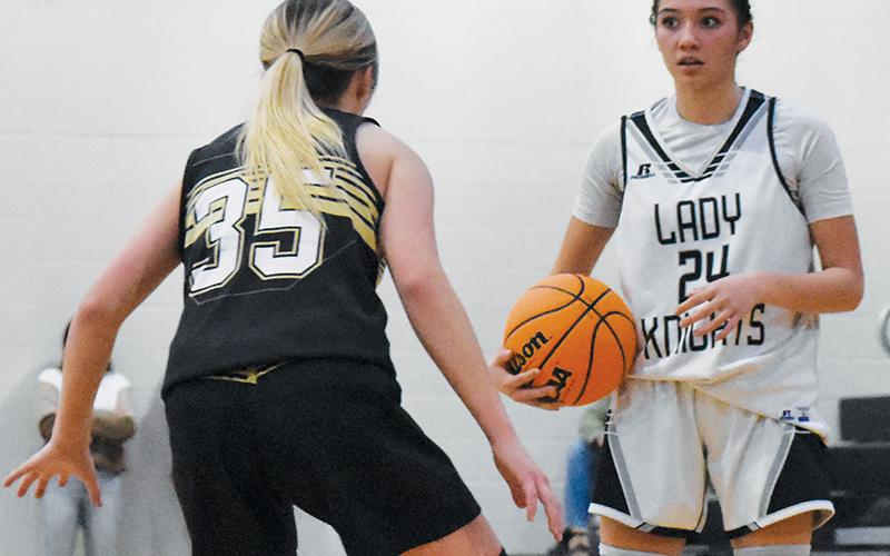 Lady Knights point guard Zayleigh Chekelelee scans the floor for passing options Monday against  Hayesville. Chekelelee recorded 22 points against the Lady Jackets in Robbinsville’s victory. Photo by Bella Eddings/The Graham Star