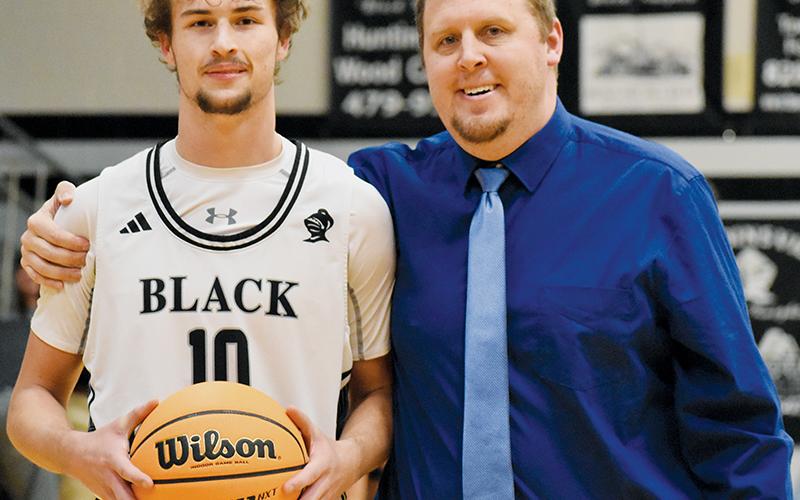 Robbinsville senior Bryce Adams became just the fifth Black Knight in school history to reach the 1,000-point threshold Jan. 8. With Adams is head coach Jake Beasley. Photos by Jacquline Gayosso/The Graham Star
