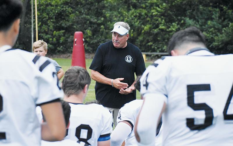 Dee Walsh gives one final pep talk before what proved to also be his final preseason scrimmage Aug. 16 at T.C. Roberson High School. After winning 189 career games in 22 seasons at his alma mater, Walsh announced he was stepping down as both head football coach and Robbinsville High School’s athletic director Friday. Photo by Kevin Hensley/sports@grahamstar.com