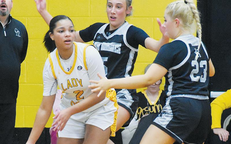 Robbinsville’s Anna Williams (5) and Suri Watty (23) trap Murphy’s Ilie Smith on Tuesday. Photos by Kevin Hensley/sports@grahamstar.com