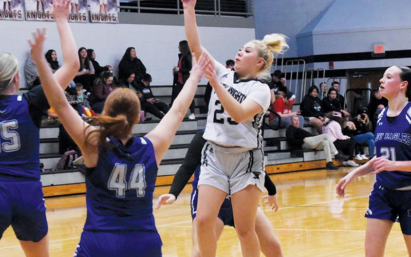 Suri Watty takes flight amongst the flocked defense of Lady Eagles Olivia McNabb (15), Bella Stiles (44), Sky Taylor and Abby Harris (21) on Jan. 14. Photo by Kyla Garland/The Graham Star