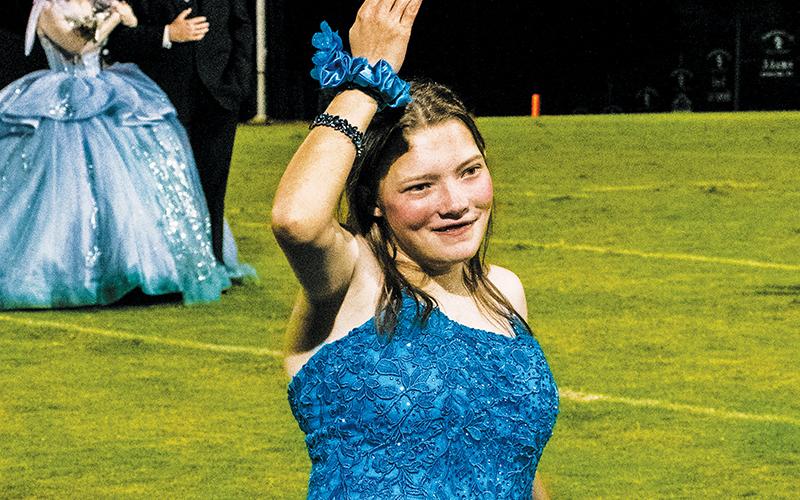 Robbinsville High School senior Shalimar Daniels soaks in the adulation of fans across Big Oaks Stadium on Oct. 4, after being introduced as an honorary attendant during homecoming. Photo by Royce Worbington/The Graham Star