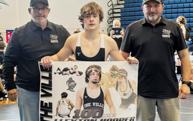 Black Knight Lleyton Hooper secured his 100th career win at Saturday’s Enka Duals. With Hooper is assistant coach David Haney (left) and head coach Travis Hooper. Photos courtesy of Robbinsville Wrestling