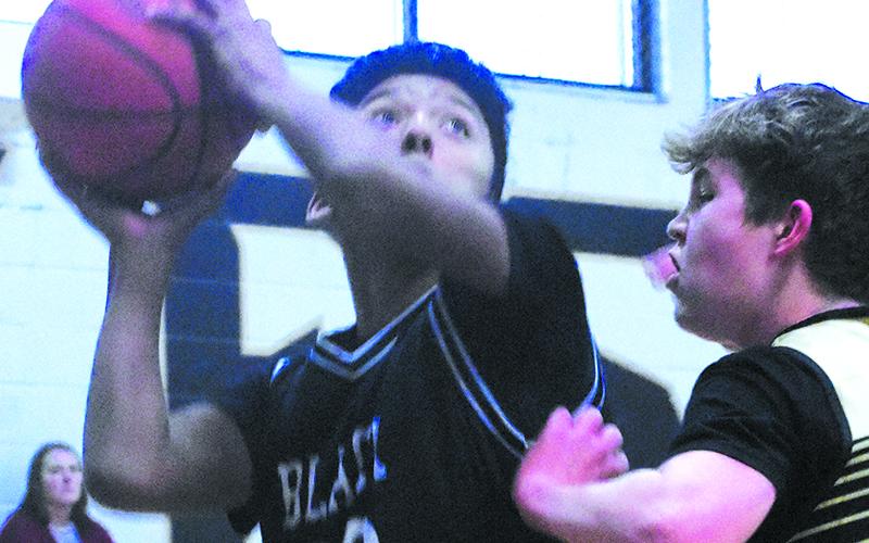 Black Knight David Guzman edges his way toward the basket during Jan. 15’s regular-season finale against the Yellow Jackets.