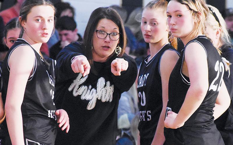 Brooke Cox, Ella Nelms and Myah Winfrey (from left) listen intently as Robbinsville head coach Brittany Snider sets up a play during a late timeout Jan. 15 at Hayesville. Photos by Kevin Hensley/sports@grahamstar.com