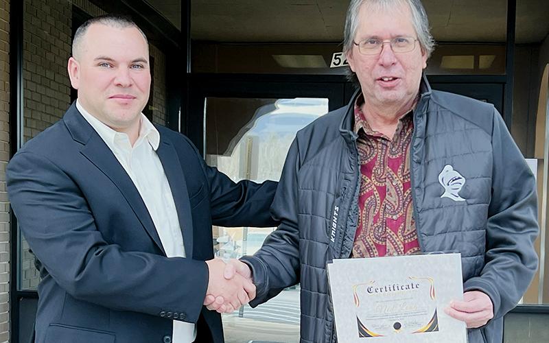 Ned Long (right) received a certificate of recognition at Tuesday’s Graham County Board of Education meeting, for his contributions toward the field of Indian  Education. Long will retire Friday. With Long is Eastern Band of Cherokee Indians Snowbird and Cherokee County Services Director D.J. Robinson. Photo by Kevin Hensley/editor@grahamstar.com
