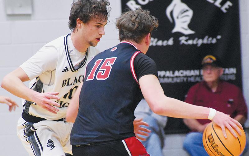 Robbinsville senior Bryce Adams – shown guarding Andrews’ Braxton Rickett on Friday – surpassed the 1,100-point mark for his career Monday against Summit Charter. Photo by Bella Eddings/The Graham Star