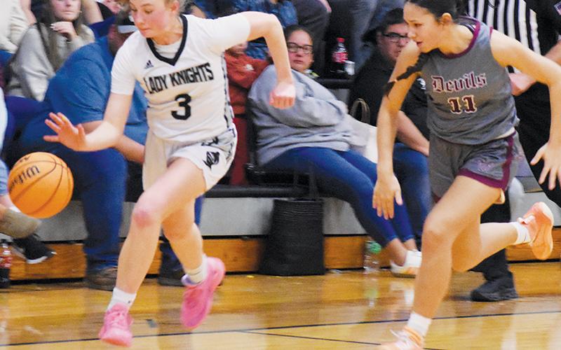 Under the hot pursuit of Swain County’s Miley Teav (11), Abby Wehr breaks up the floor during the second half of Friday’s win over the Lady Devils. Wehr led Robbinsville with 15 points in the victory. Photo by Kensie Belk/The Graham Star