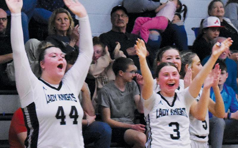 Members of the Robbinsville Lady Knights hit the floor to celebrate with their teammates after Tuesday’s conference win over Hayesville. From left are Bentley Riggins, Abby Wehr, Liz Carpenter and Anna Williams. Photos by Kyla Garland/The Graham Star