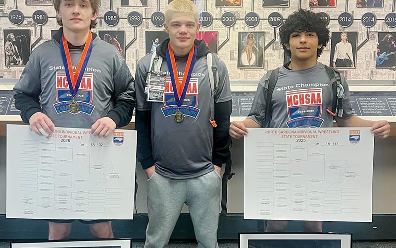 Loxston Hooper, Skyler Anderson and Adair Panama (from left) each conquered their respective brackets during the individual state tournament, bringing home three more gold medals for the reputable Black Knights’ wrestling program. Photo courtesy of Brooke Haney/Robbinsville Wrestling