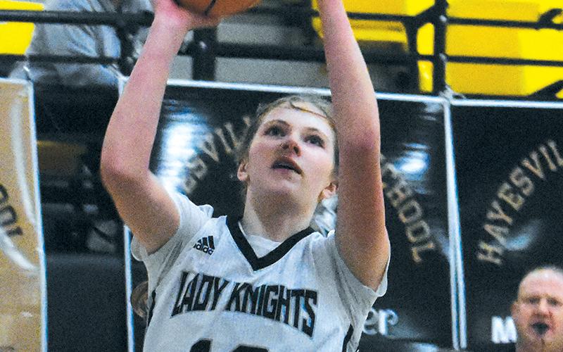 Lady Knights freshman Zaelyn Phillips evades Murphy’s Cayla Geer for a lay-up attempt during Feb. 15’s conference-tournament quarterfinal. Photo by Kevin Hensley/sports@grahamstar.com