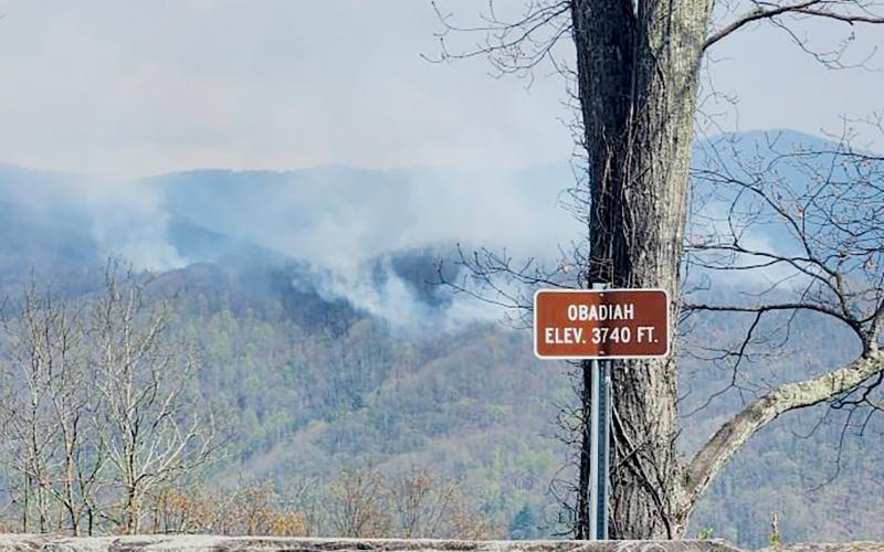 On-ground personnel worked to combat the Haoe Lead Fire inside the Joyce Kilmer Memorial Forest by creating a burn Monday. The smoke from Monday’s start can be seen in the center of this photo from the Obadiah Overlook on the Cherohala Skyway; to the left is smoke from the original fire, which started April 12. Photo courtesy of Joe Leak/U.S. Forest Service Safety Officer, Southern Area Gray Incident Management Team