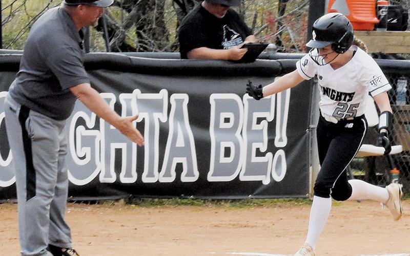 Robbinsville skipper Billy Knight (left) waits to congratulate Lexie Williams after her two-run homer April 3 against Smoky Mountain. Photo by Kyla Garland/The Graham Star