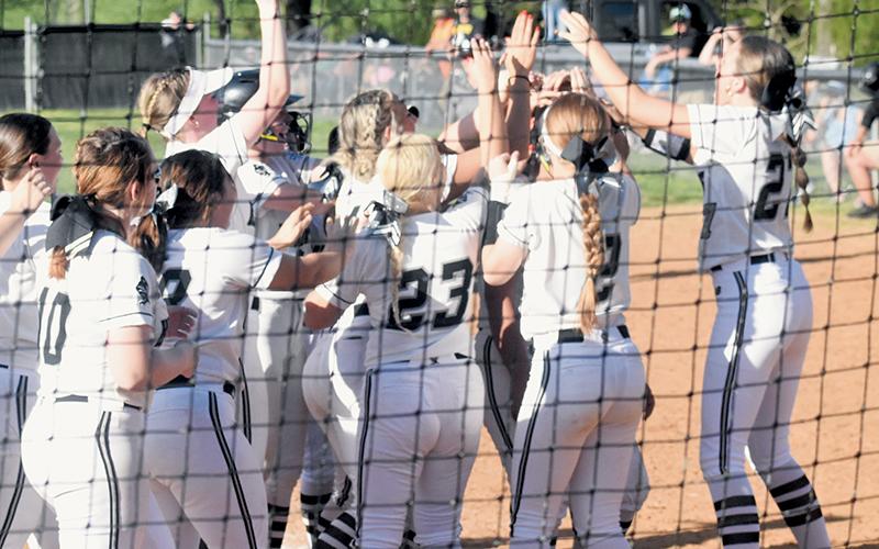 Robbinsville senior Naomi Taylor gets lost in a sea of Lady Knight players Friday, as she was greeted at home plate following her go-ahead home run against Murphy. Photo by Lexie Anderson/The Graham Star