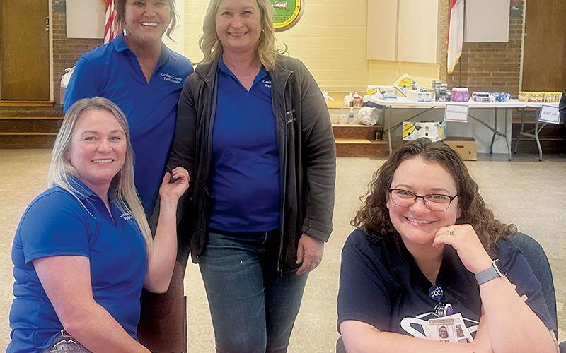 Members of the Graham County Department of Public Health helped with a mobile pharmacy visit Friday.  Seated in front are Jessica Yates (left) and Rosie  Roessler. Standing in back are director Donna Stephens (left) and Shawn Turpin. Photo by Latresa Phillips/The Graham Star