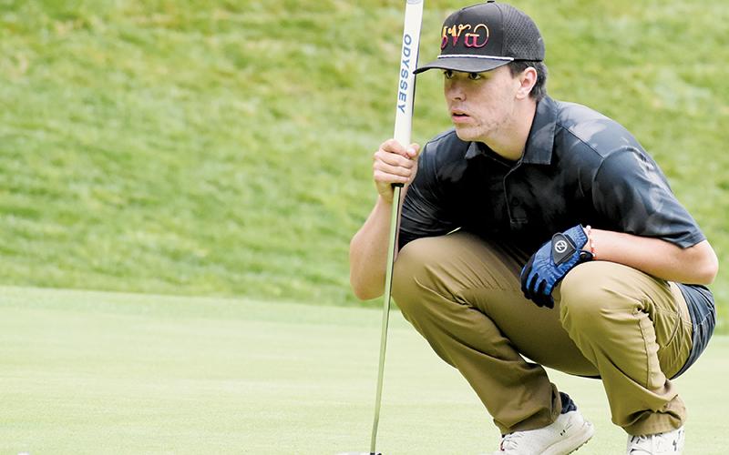 Avery Brown sizes up a putt April 24 at the conference tournament opener. Photo by Kevin Hensley/sports@grahamstar.com