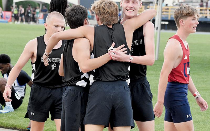 Austin Bohn, Colton McCoy and Nathan Frederick greet Cameron Allison moments after Robbinsville's 4x400 relay team clinched third place at Friday's state meet. Photo by Kevin Hensley/sports@grahamstar.com