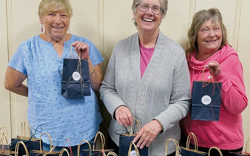 Randy Martins, Catherine Yost and Jane Kvetko (from left) show off the gift bags that have been put together for Saturday's Women's Health Forum in Andrews.