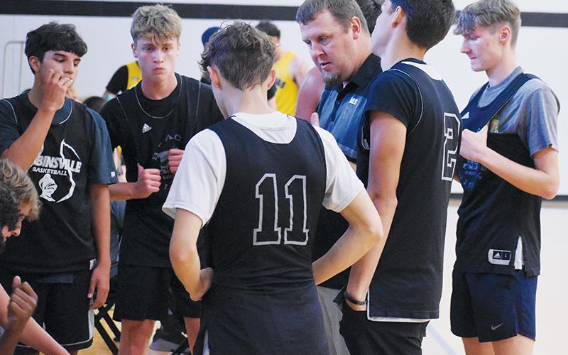 Black Knights head coach Jake Beasley discusses strategy with his players during a timeout at Monday's scrimmage against Murphy. Robbinsville finished its summer with 18 exhibitions under its belt. Photo by Kevin Hensley/sports@grahamstar.com
