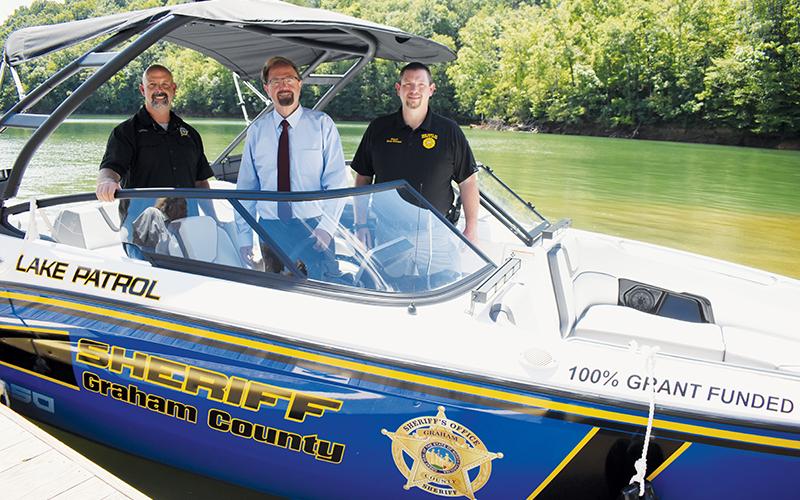 A new search and rescue boat – for use in both Graham and Swain counties – was unveiled on the shores of Fontana Lake on Aug. 14. From left are Graham County Sheriff Brad Hoxit; U.S. Rep. Chuck Edwards (R-Hendersonville), who helped obtain the funding to purchase the boat; and Swain County Sheriff Brian Kirkland. Photo by Kevin Hensley/editor@grahamstar.com