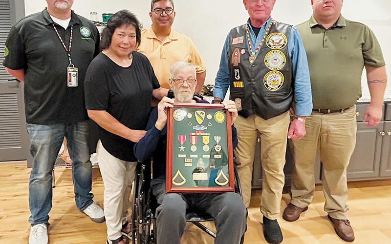 Johnny Harrison Holloway (seated, center) bravely served his country in the Vietnam War. On July 18, medals and honors lost throughout the years were re-issued during a ceremony at New Hope Baptist Church. Standing next to Holloway is his wife Kathy. Across the back are veterans Gerard Ball, Adam Wachacha, Warren Dupree and Josh Holloway.