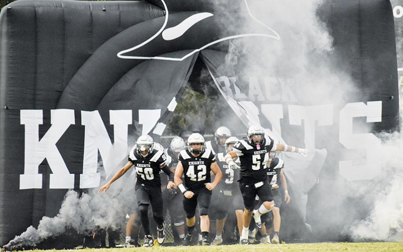 Leading the Black Knights out of their new community-funded tunnel Friday were Bracey Wilson (50), Ryelon Waldroup (42) and Kellen Ensley (54).
