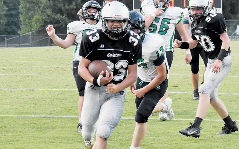 Kreed Williams rushes into the end zone to wrap up a 16-0 shutout of the Mountain Heritage Cougars during Aug. 21’s JV season opener. Photo by Lexie Anderson/The Graham Star